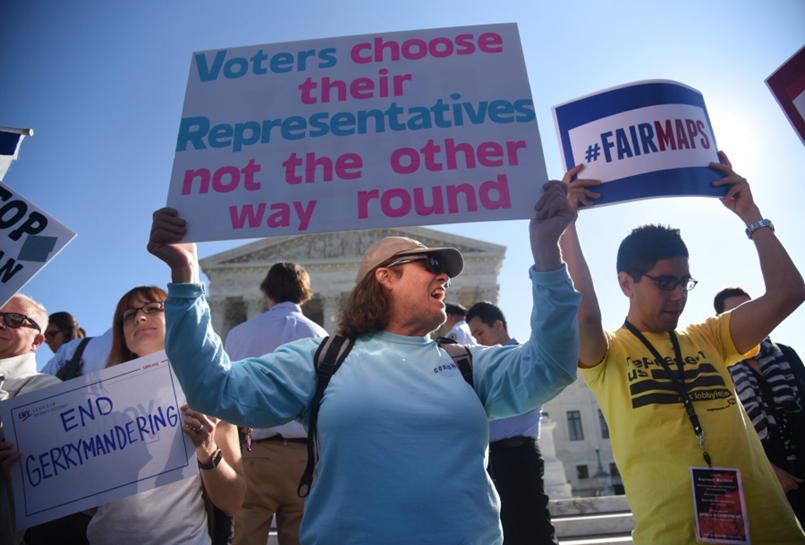 A group of people protesting partisan gerrymandering as unfair to voters